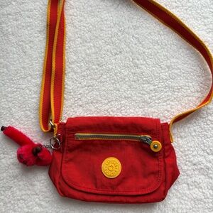 Y2K Kipling red and yellow Sabian mini crossbody bag with signature monkey